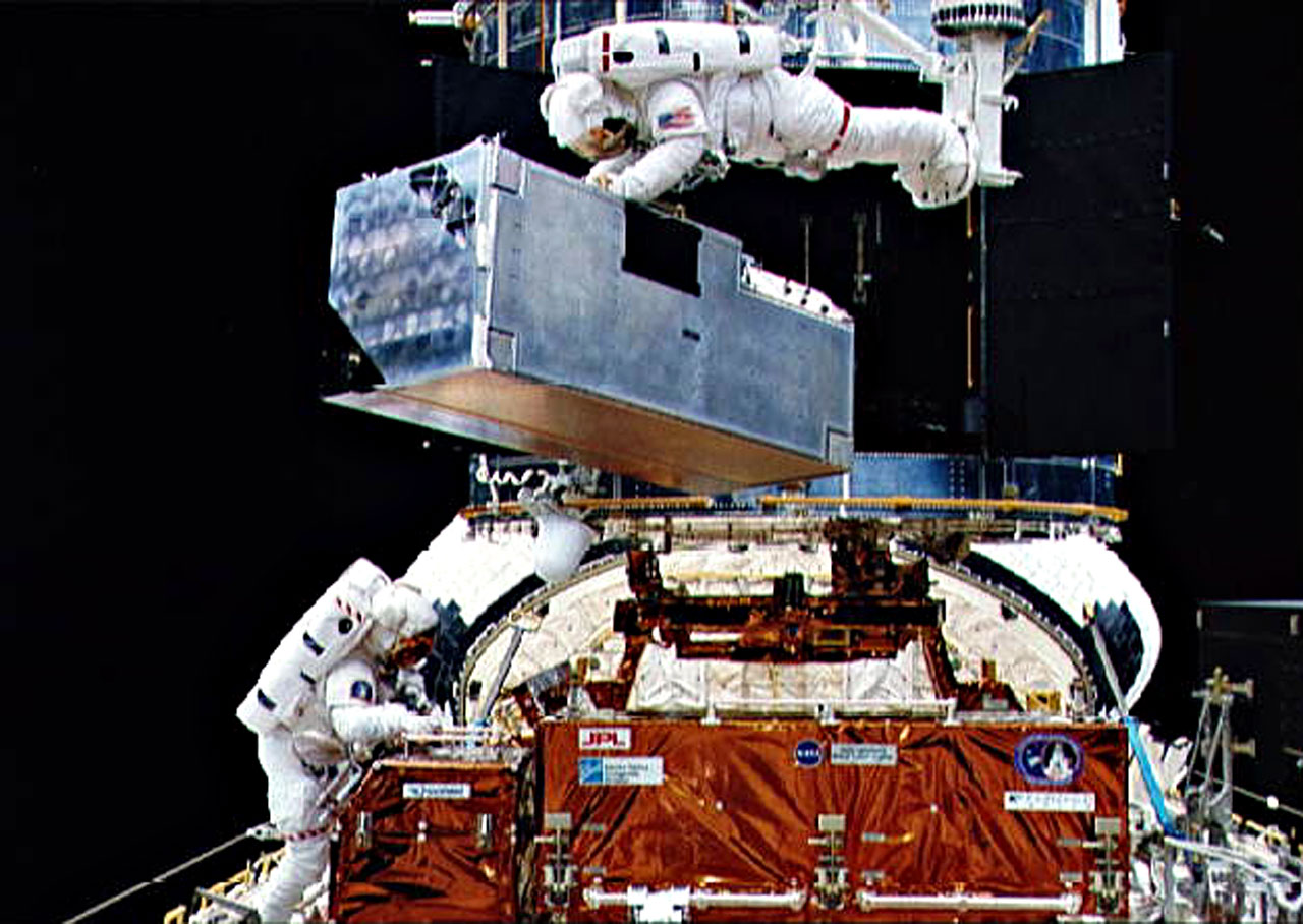 COSTAR being inserted into Hubble during First Servicing Misson.